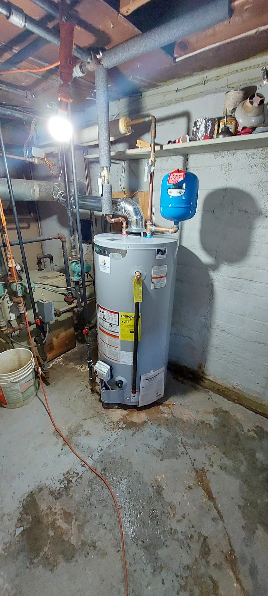 A person holding a baby up in the air indoors near a window, baby smiling.