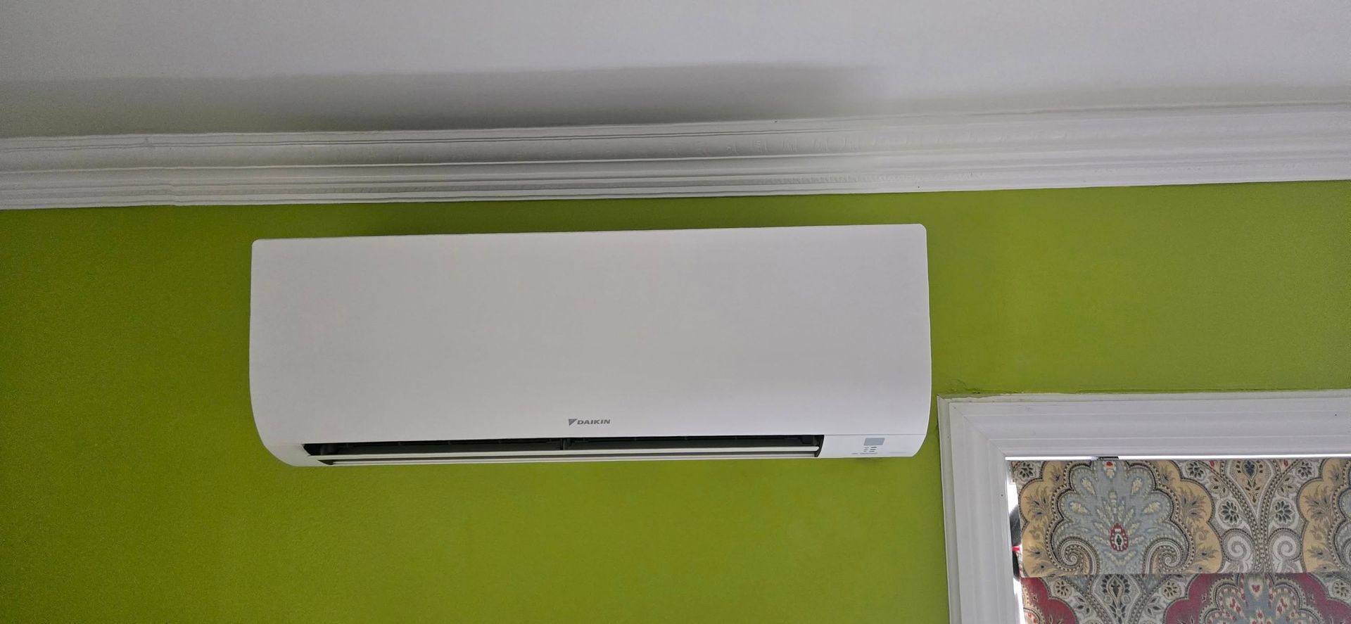 Family gathered at a dining table in a kitchen. They are eating and talking together.