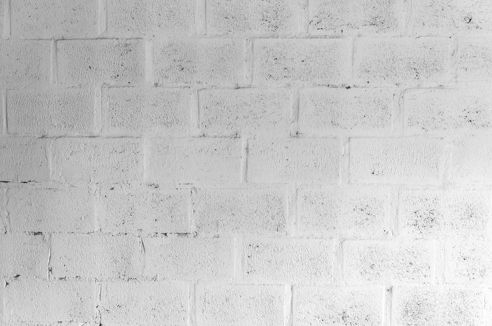 White painted cinder block wall.