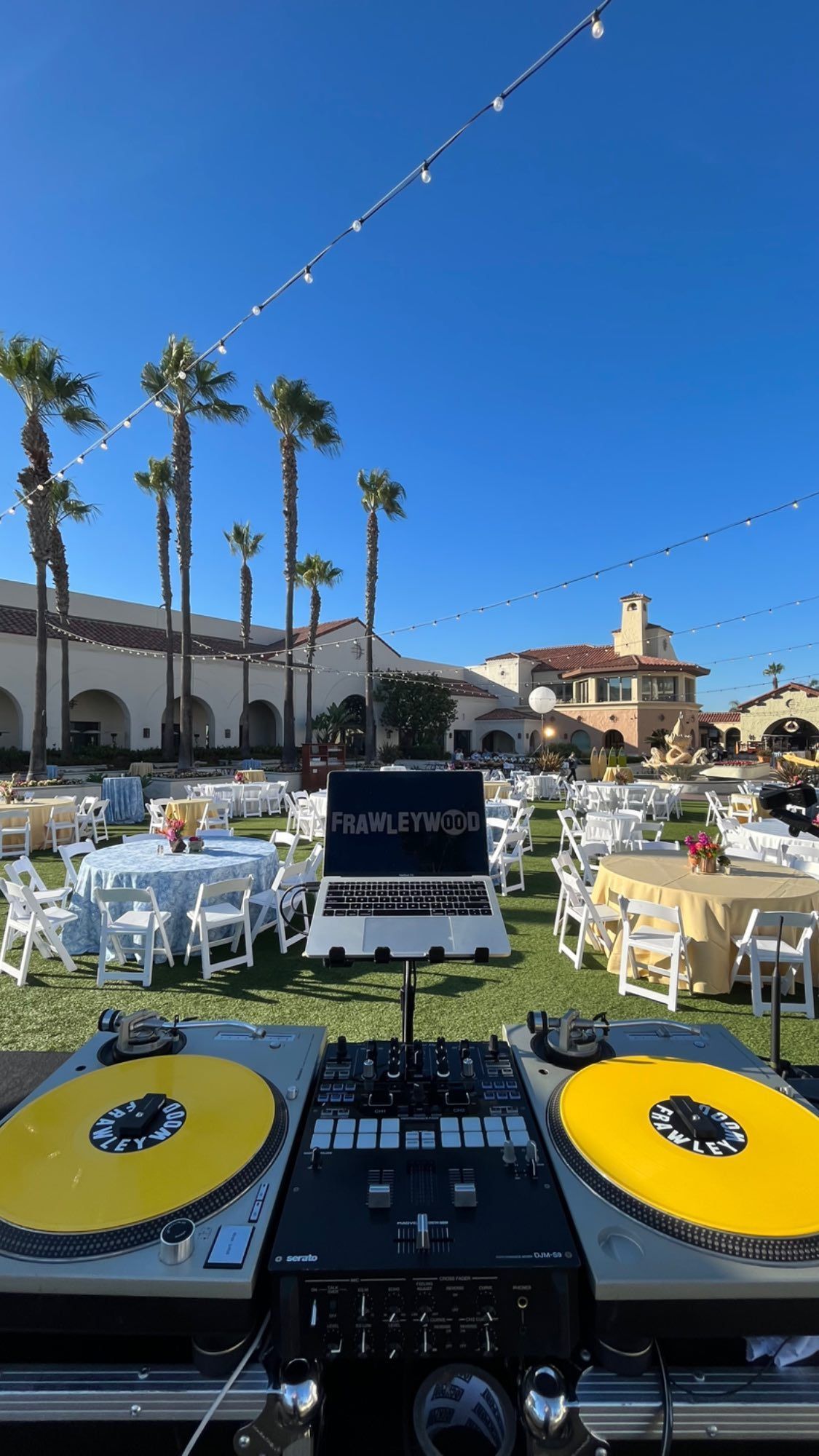 A dj is playing music at a wedding reception.