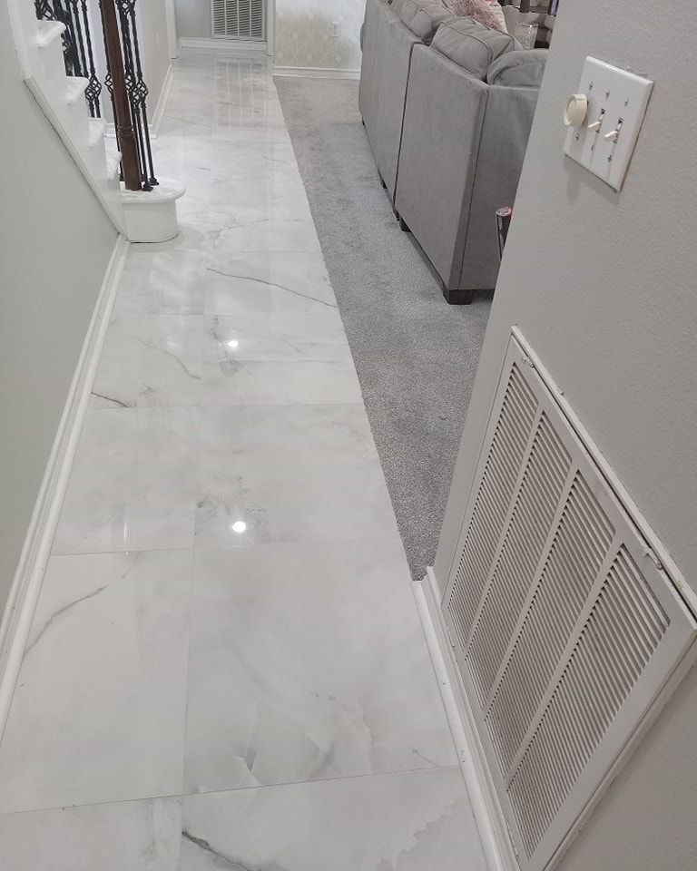 Marble floor hallway with stairs, sofa, and HVAC vent.