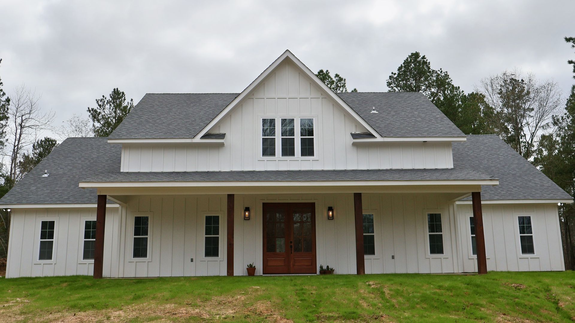 Interior view of a building under construction, showing wooden framing, roof rafters, and a ladder.
