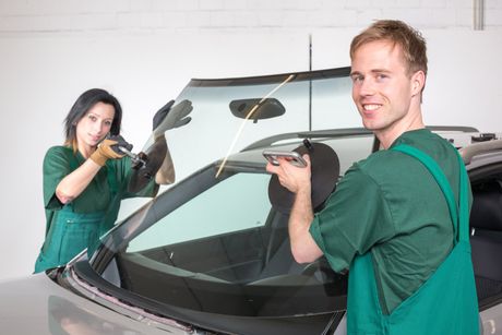 workers installing car windshield