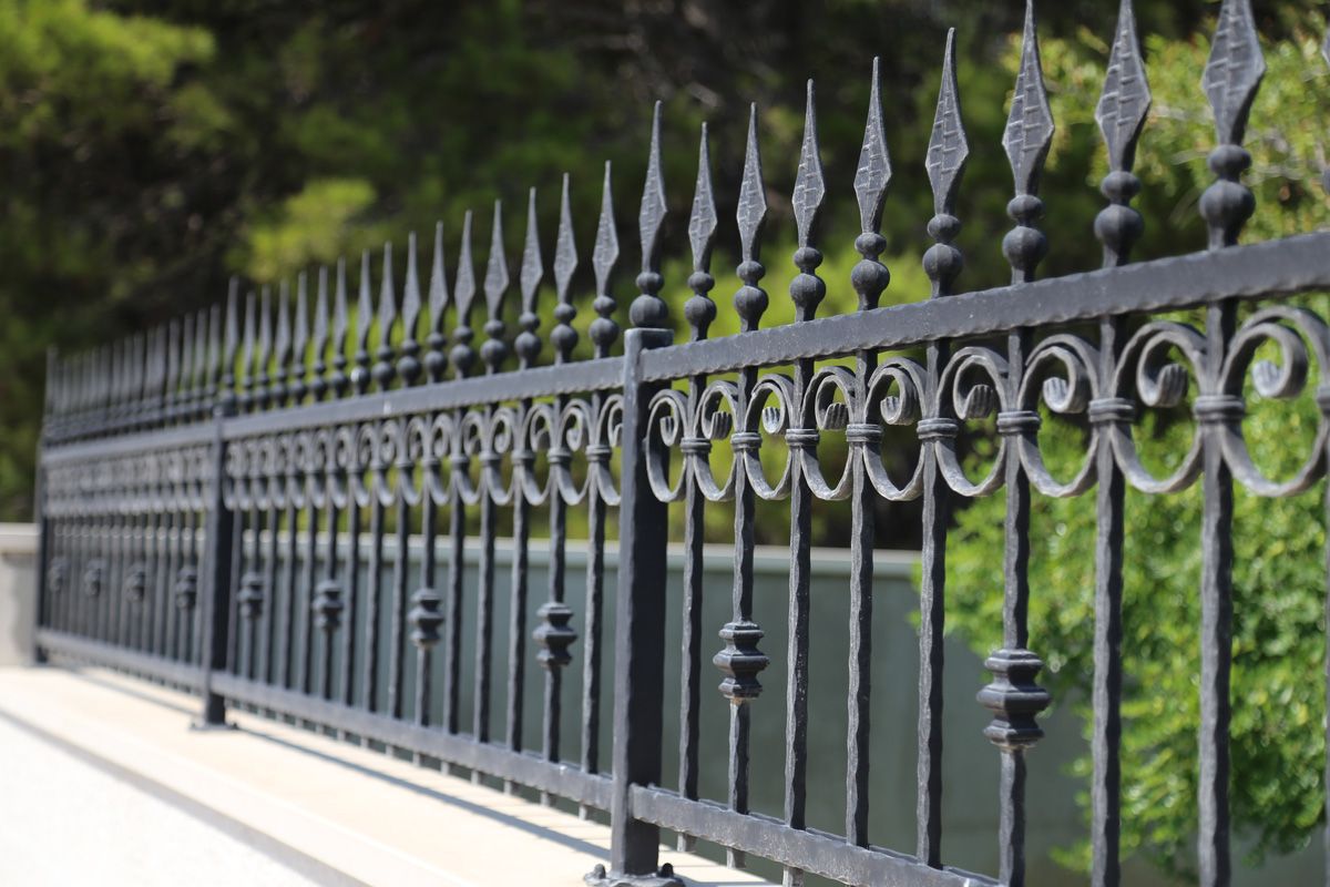 A short, black metal fence installed by a fence company in El Paso.