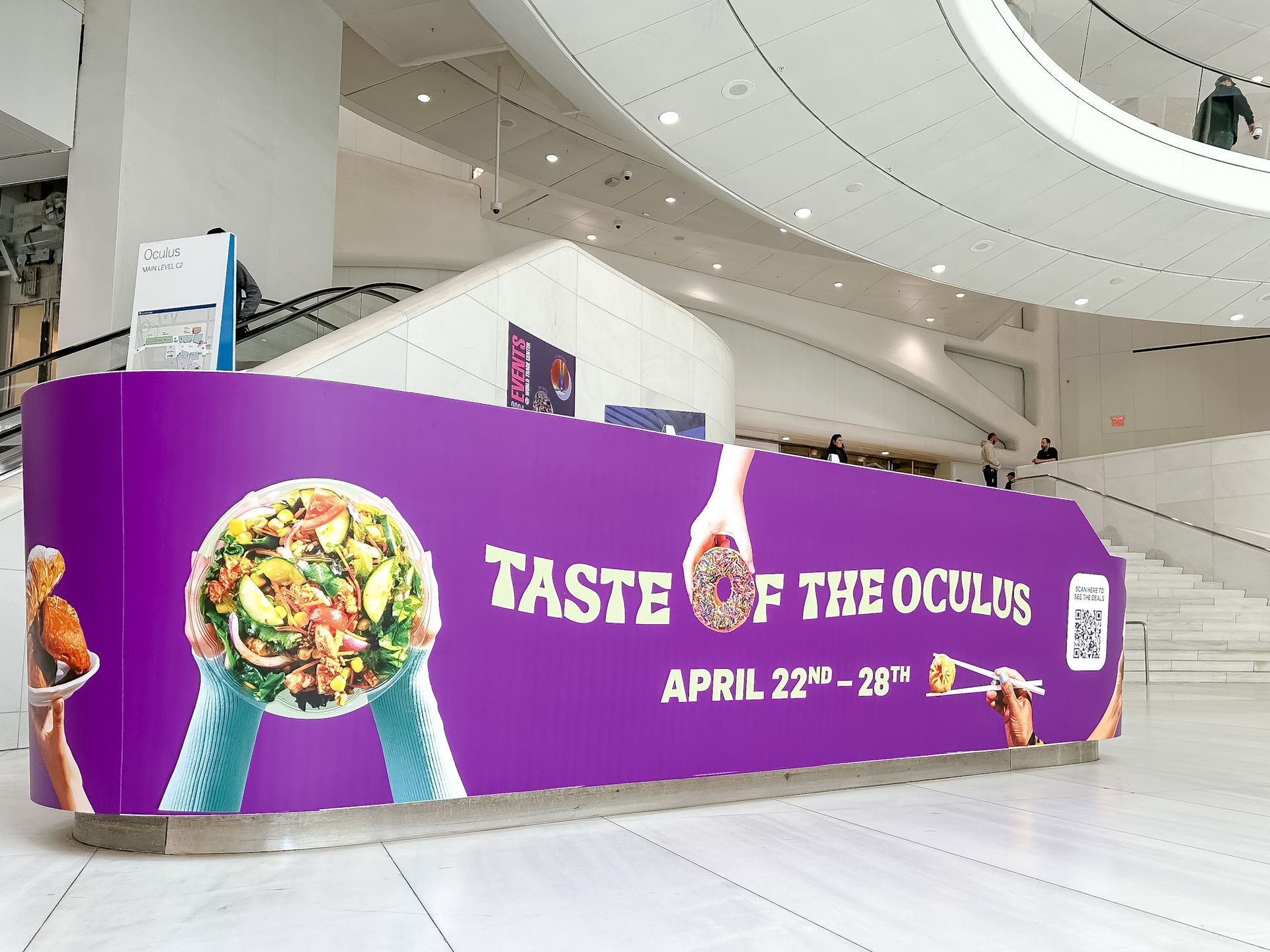 A large purple sign that says taste of the oculus