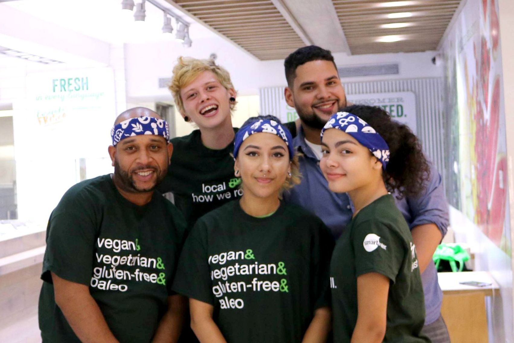 A group of people are posing for a picture in a restaurant.