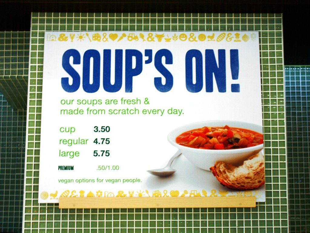 A sign that says soup 's on on it