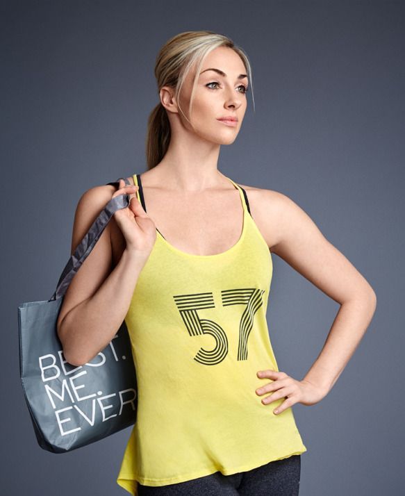 A woman wearing a yellow tank top with the number 57 on it