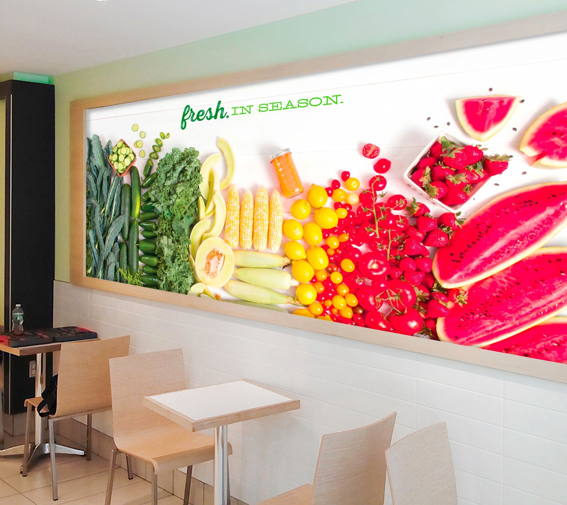 A picture of fruits and vegetables on a wall that says fresh on it