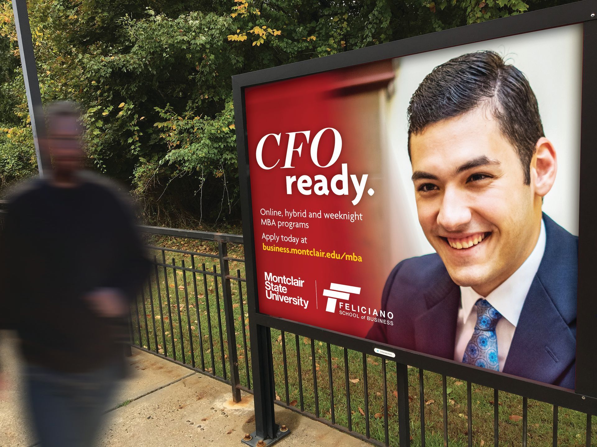 A man walking past a billboard that says cfo ready