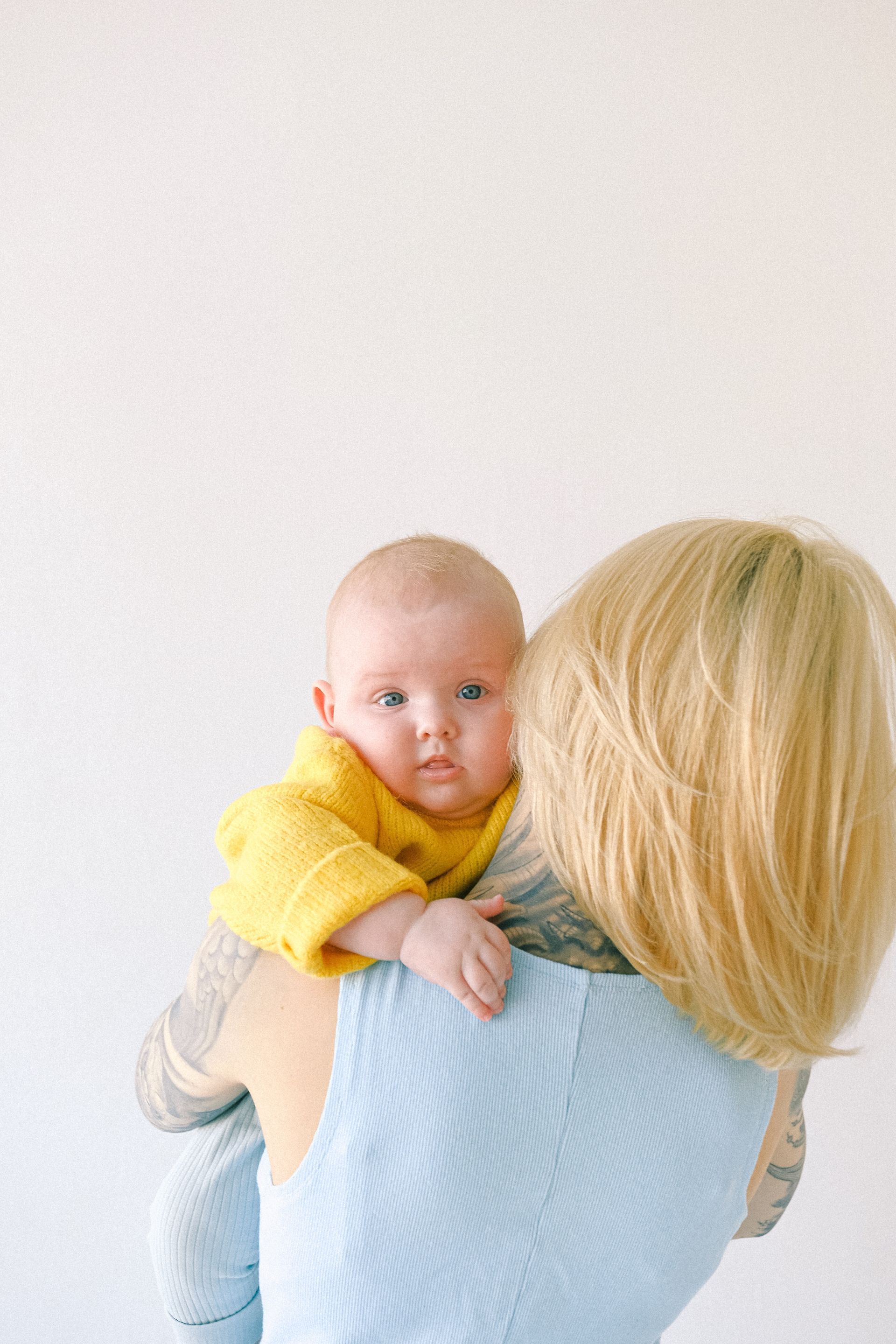 A woman is holding a baby in her arms.