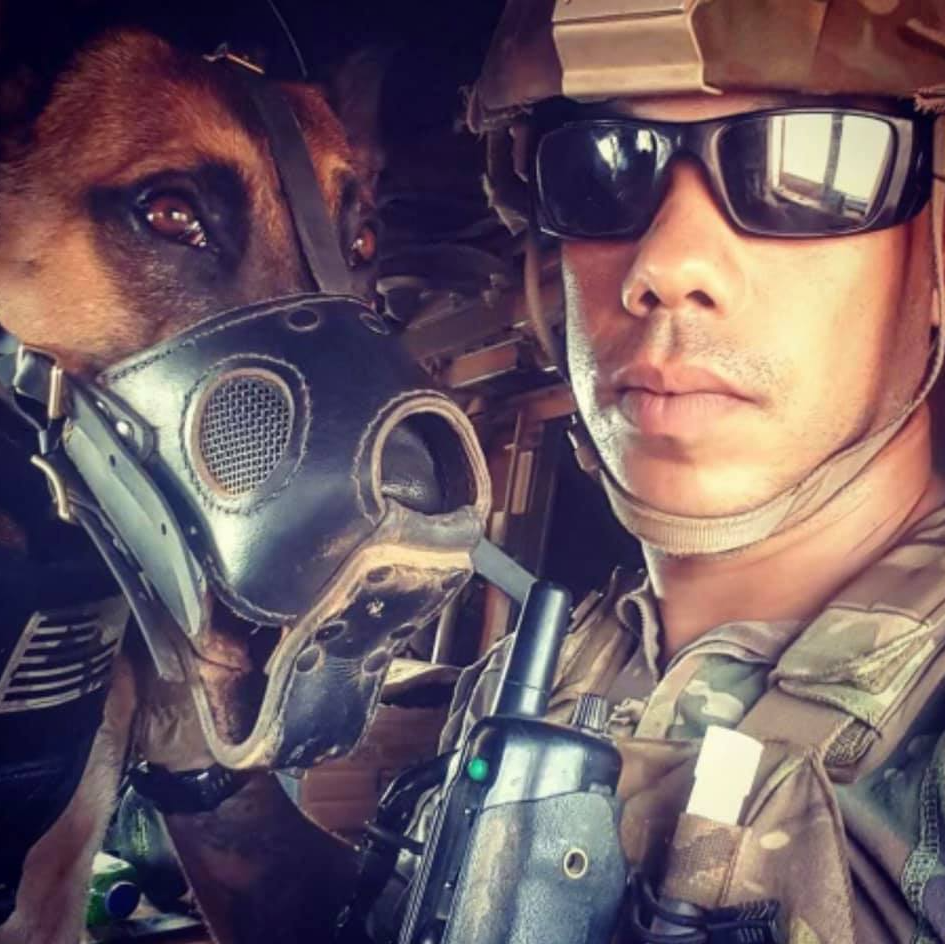 A man and a dog wearing gas masks and sunglasses