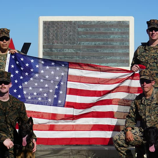 A group of soldiers holding an american flag