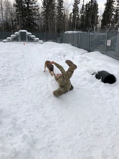 A person is laying on their back in the snow.