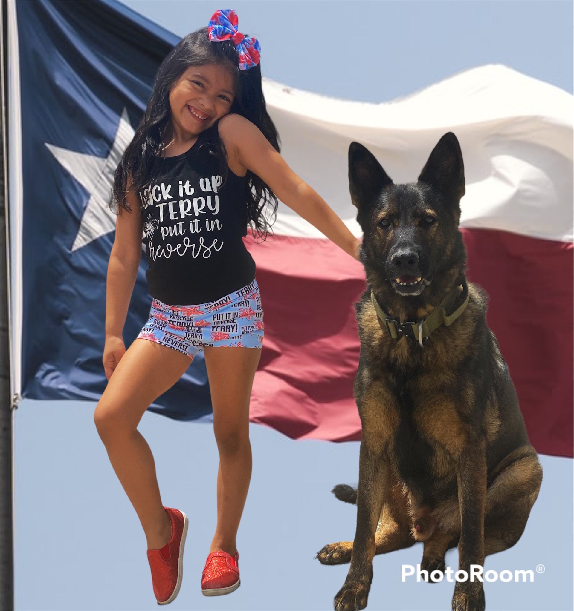 A little girl standing next to a large dog with a texas flag in the background