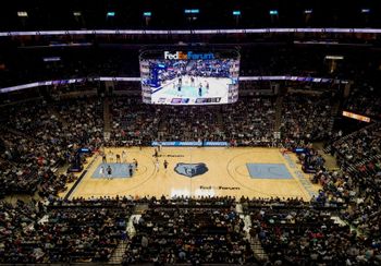 A basketball game is being played in a fedex sports stadium