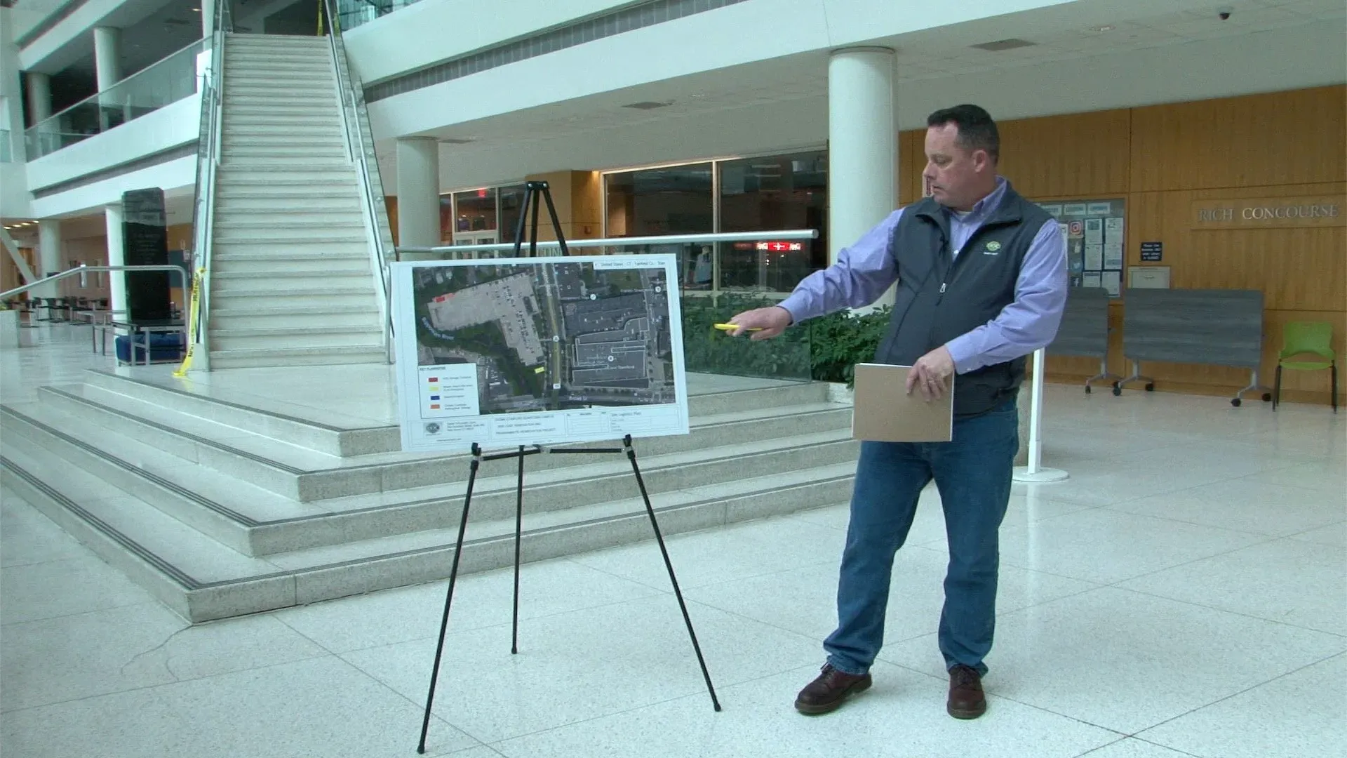 Man Explaining The Building Map