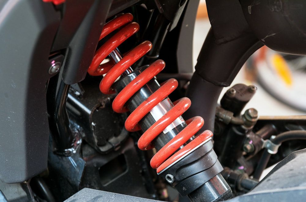 A Close Up Of A Red Shock Absorber On A Motorcycle — P & M Performance & Mechanical In Bungalow, QLD