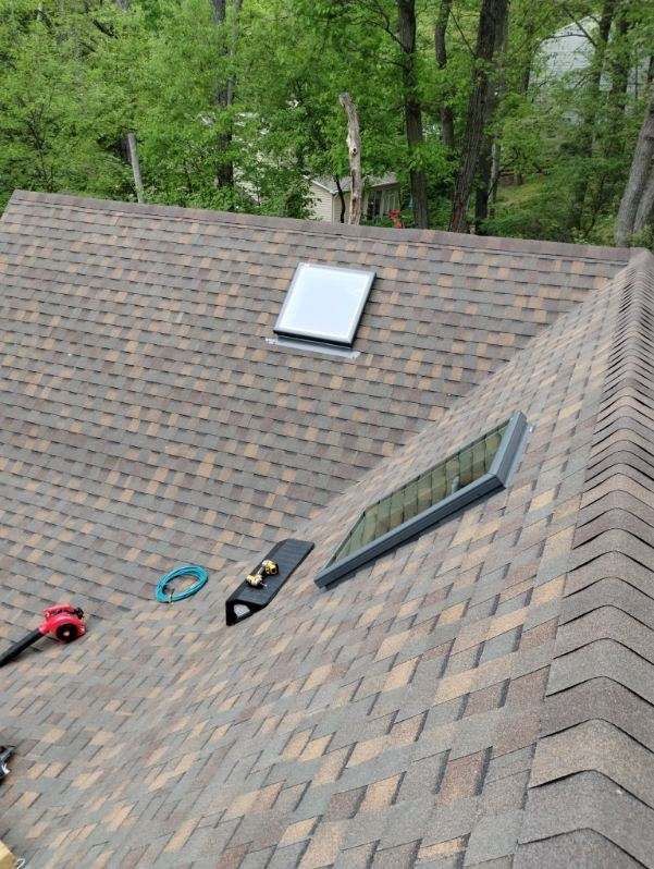 There is a skylight on the roof of a house.