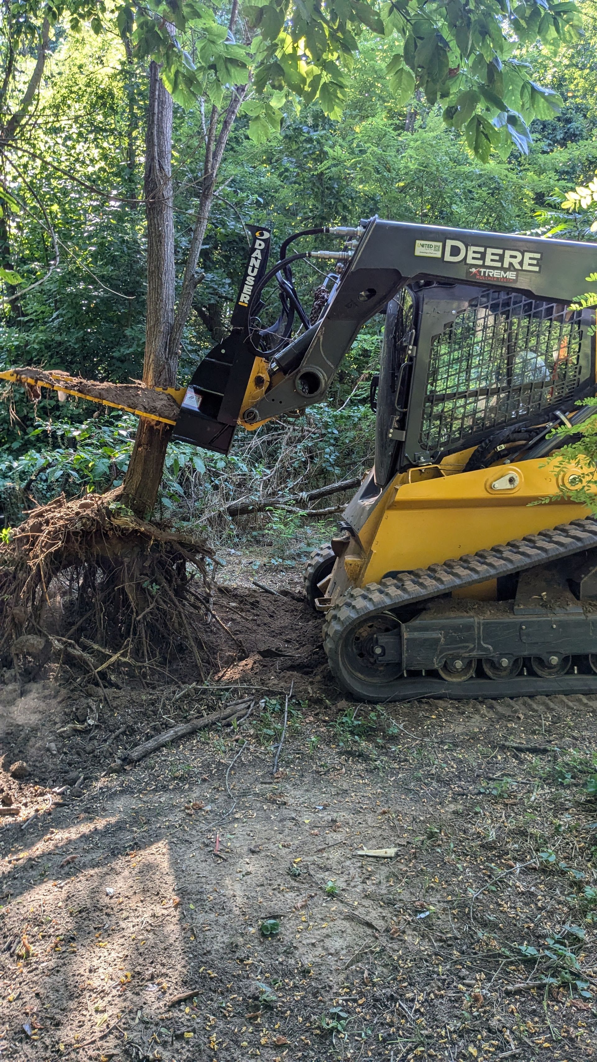 A bulldozer is sitting on top of a dirt road.
