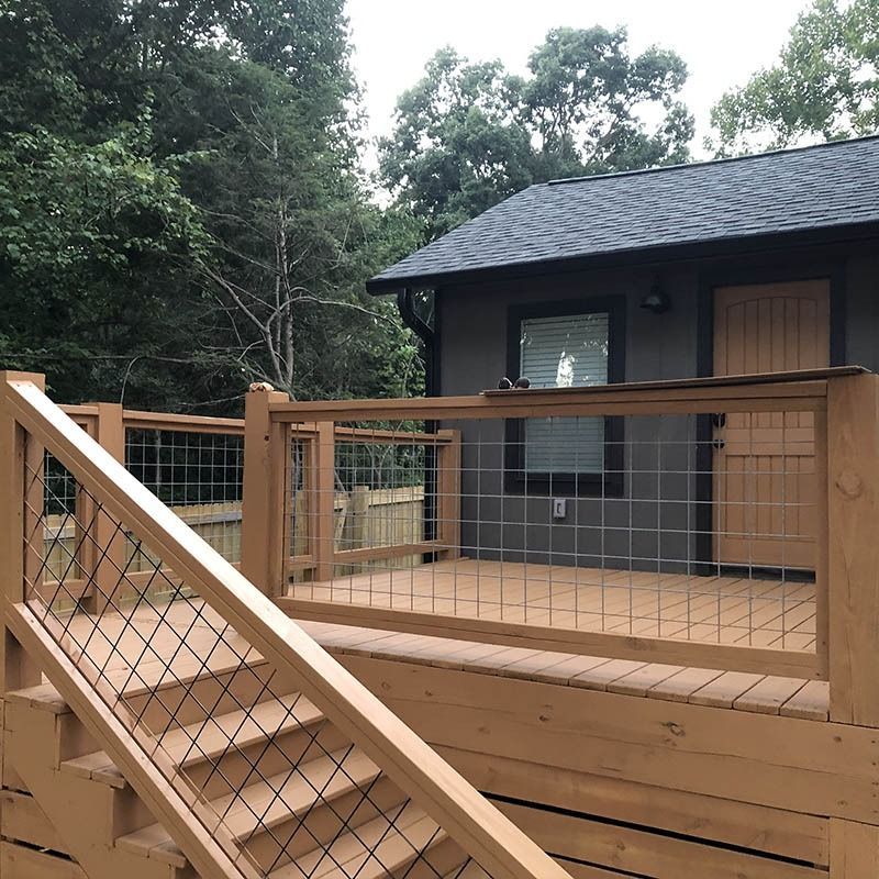 A house with a wooden deck and stairs leading up to it