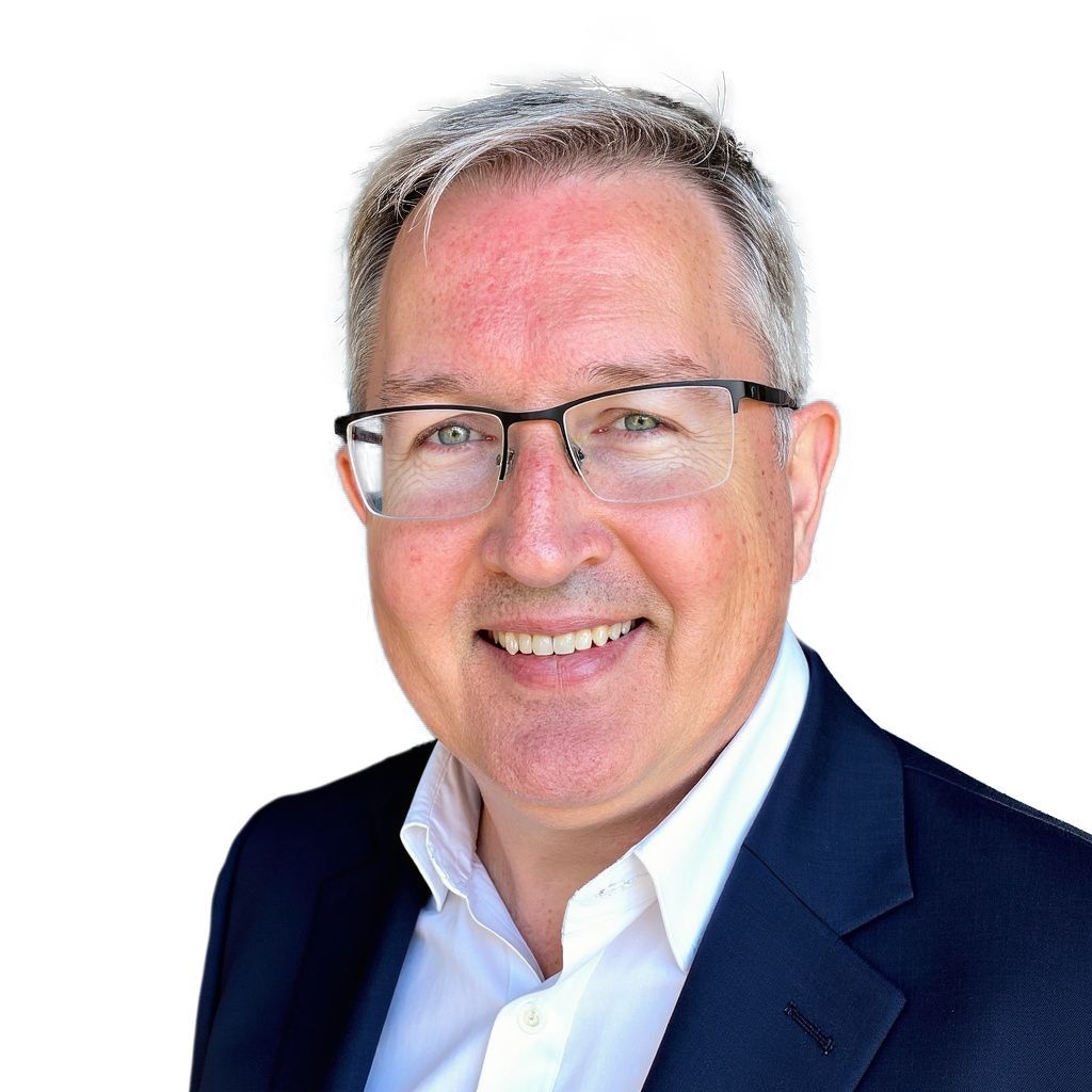 A man in a suit and shirt is smiling for the camera.