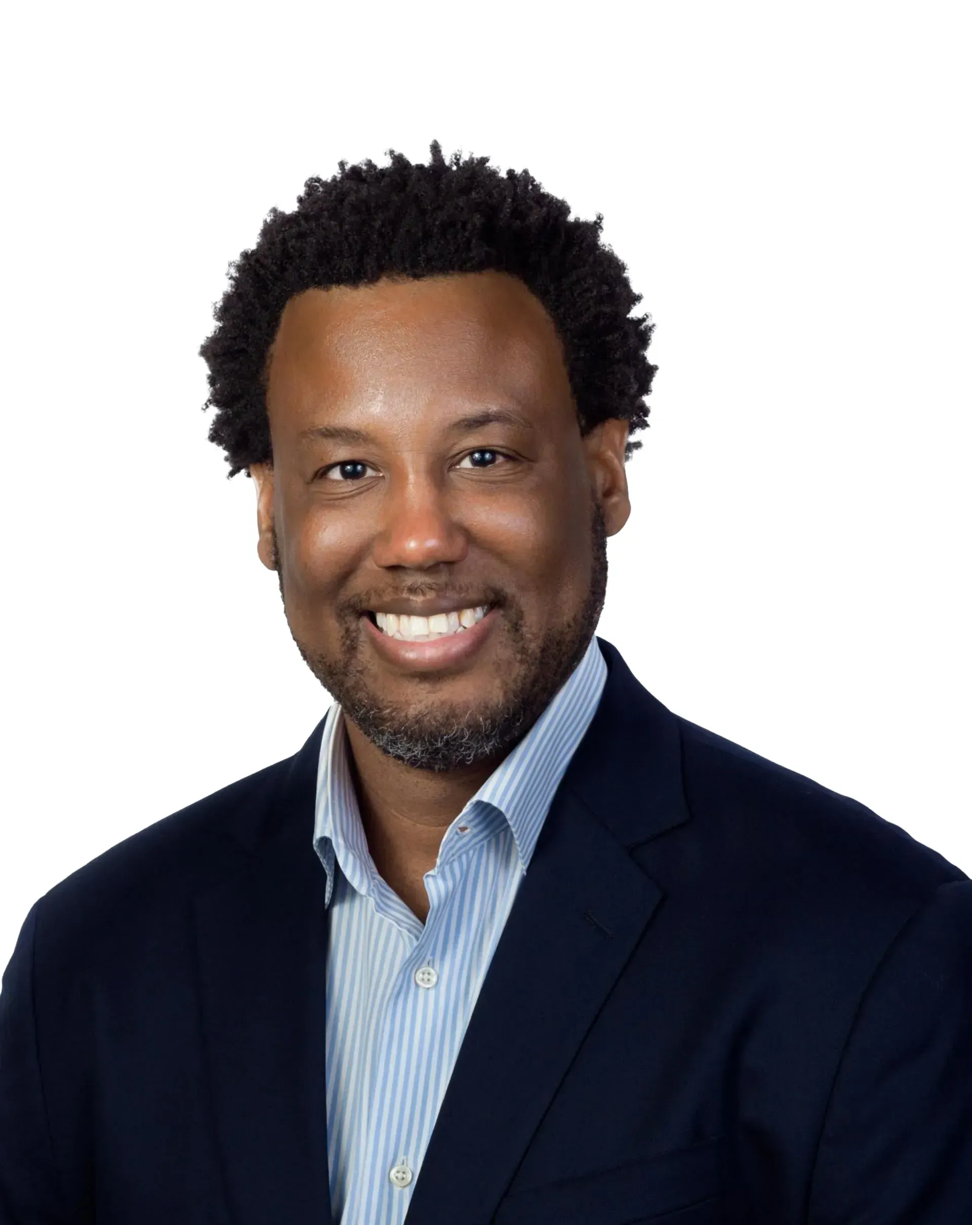 A man in a suit and striped shirt is smiling for the camera.