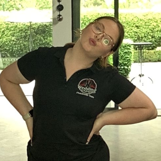 A cartoon portrait of a woman wearing glasses and smiling.