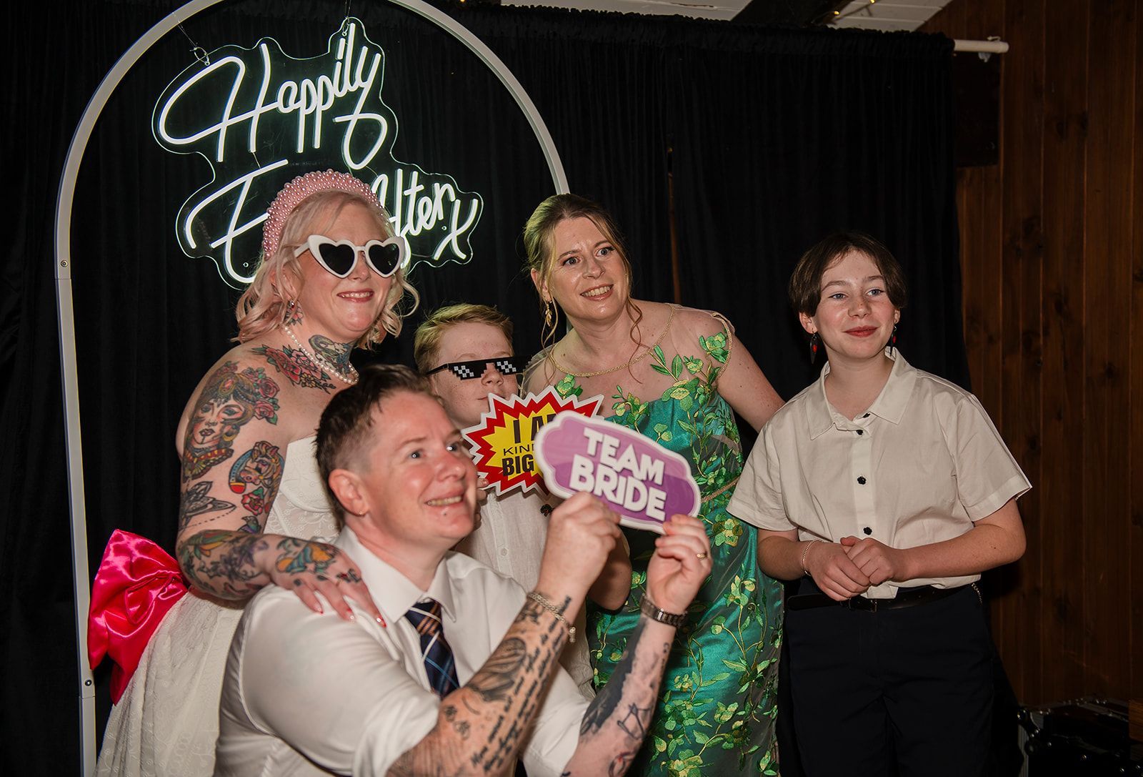 A group of people are posing for a picture in a photo booth.