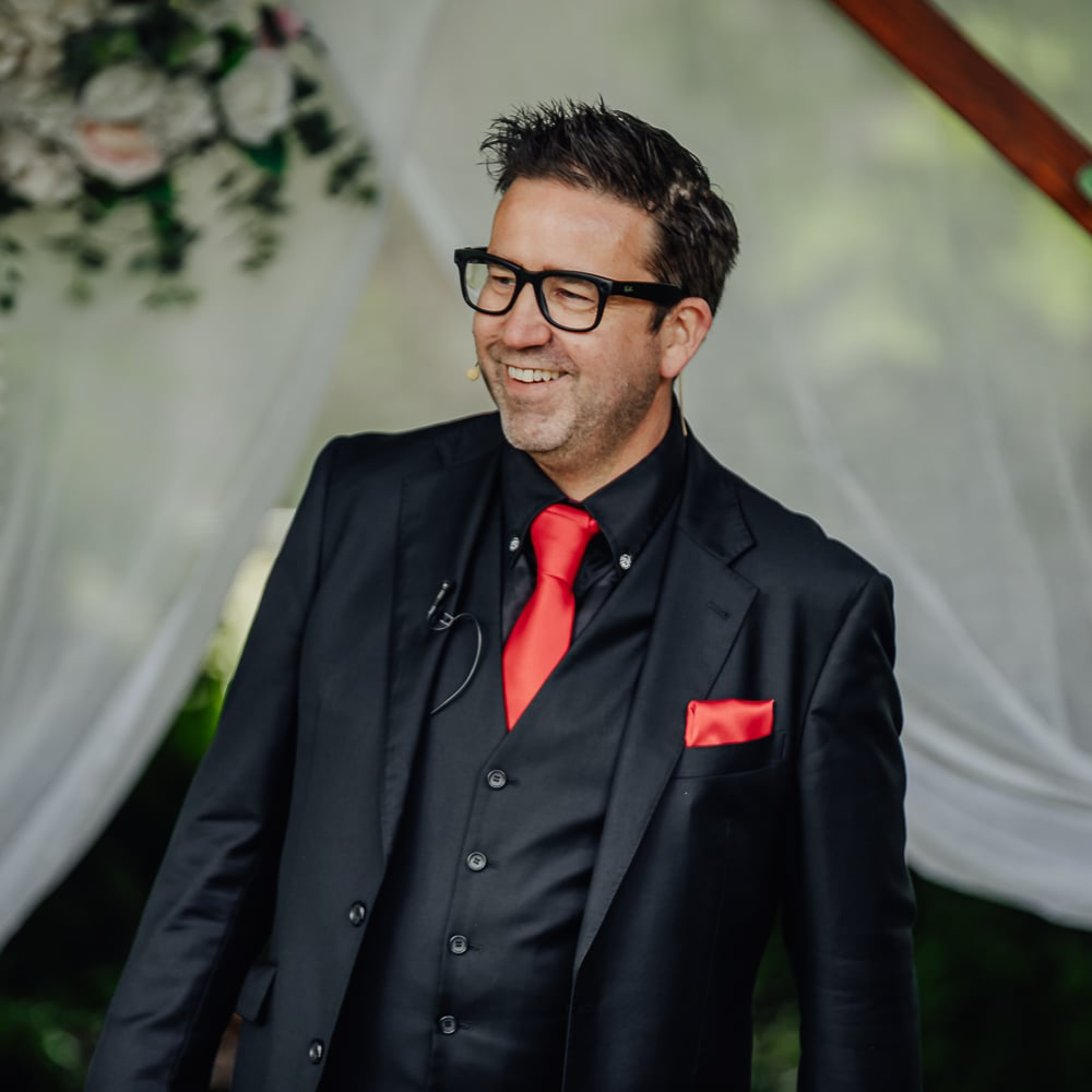 A drawing of a man wearing glasses and a black jacket