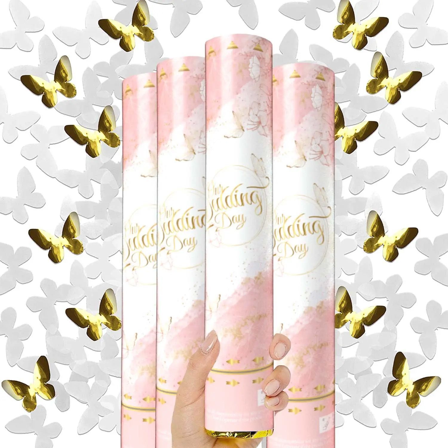 A person is holding a pink and white confetti cannon with gold butterflies on it.