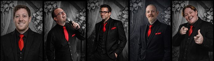 Five men in suits and red ties, posing, one with a microphone.