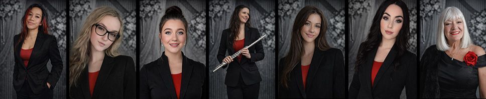 A group of musicians in formal attire, posing against a textured grey backdrop.