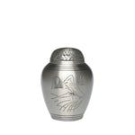 A small silver urn with a cat on it on a white background.