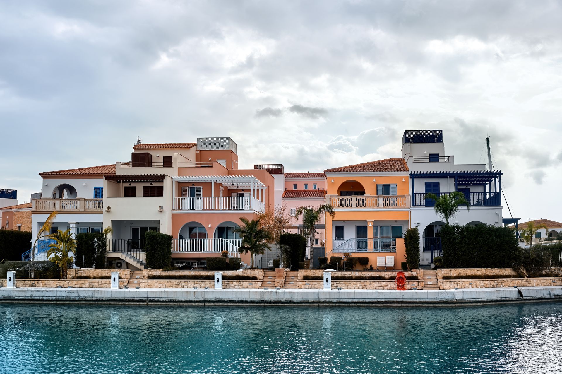 A row of houses next to a body of water