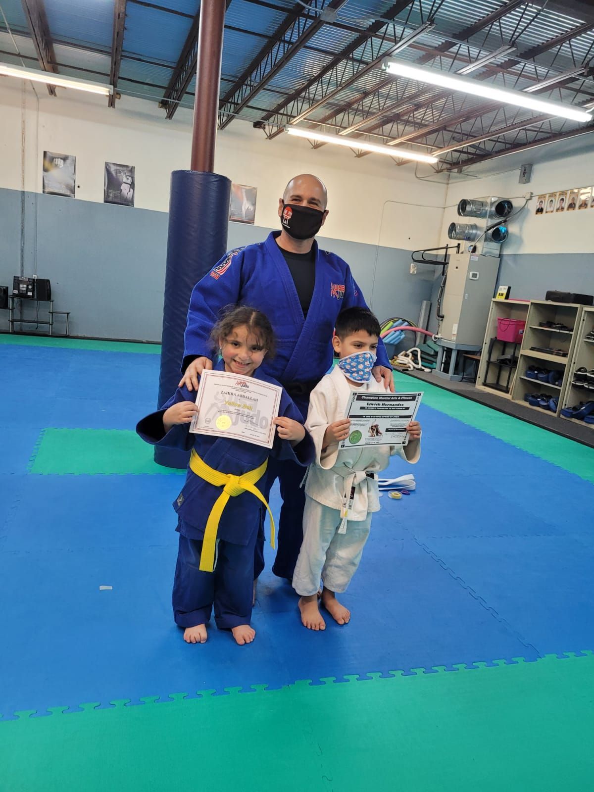 Kids practice Judo throws with coaches at Champion Martial Arts & Fitness in Pasadena, TX, building focus and discipline.