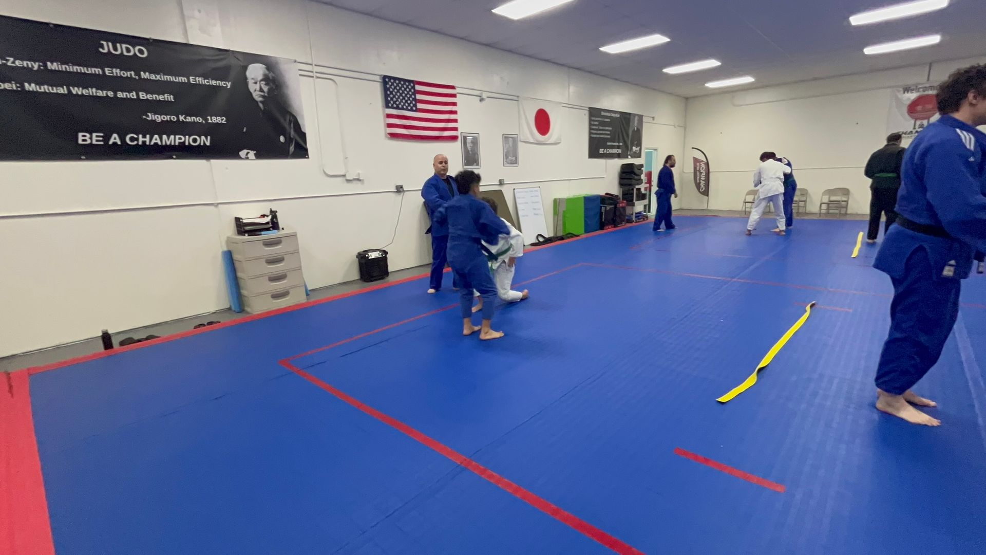 Judo students practicing controlled throws at Champion Martial Arts & Fitness in Pasadena, TX for stress relief