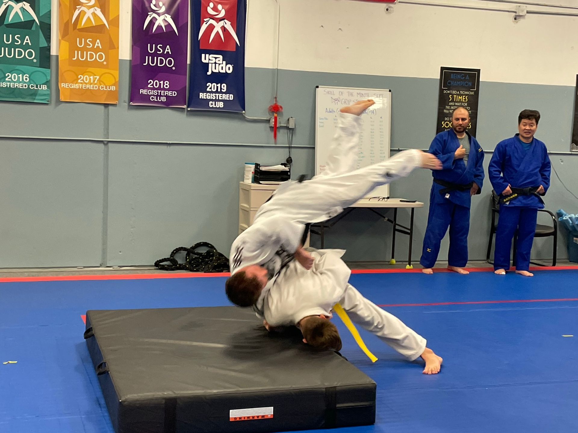 Beginner students practice safe judo throws on mats at Champion Martial Arts & Fitness in Pasadena.