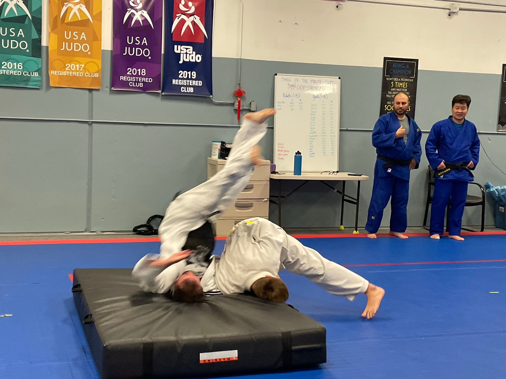 Adults practicing Judo grips and throws at Champion Martial Arts & Fitness in Pasadena, TX.
