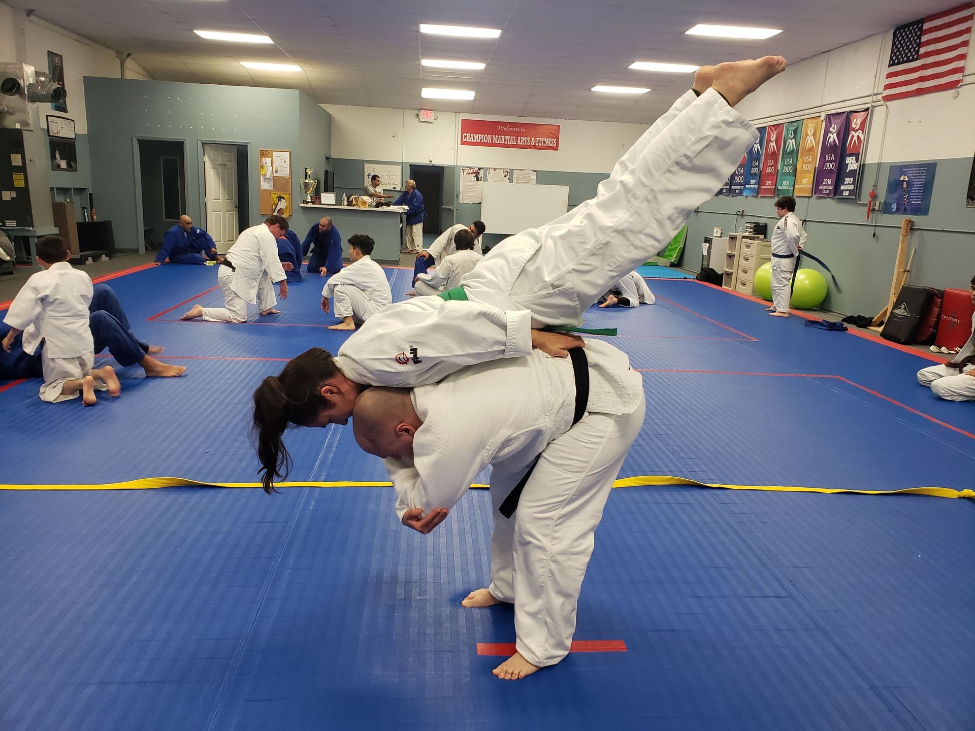 Students practice Judo breakfalls at Champion Martial Arts & Fitness in Pasadena, TX for mobility and safety.