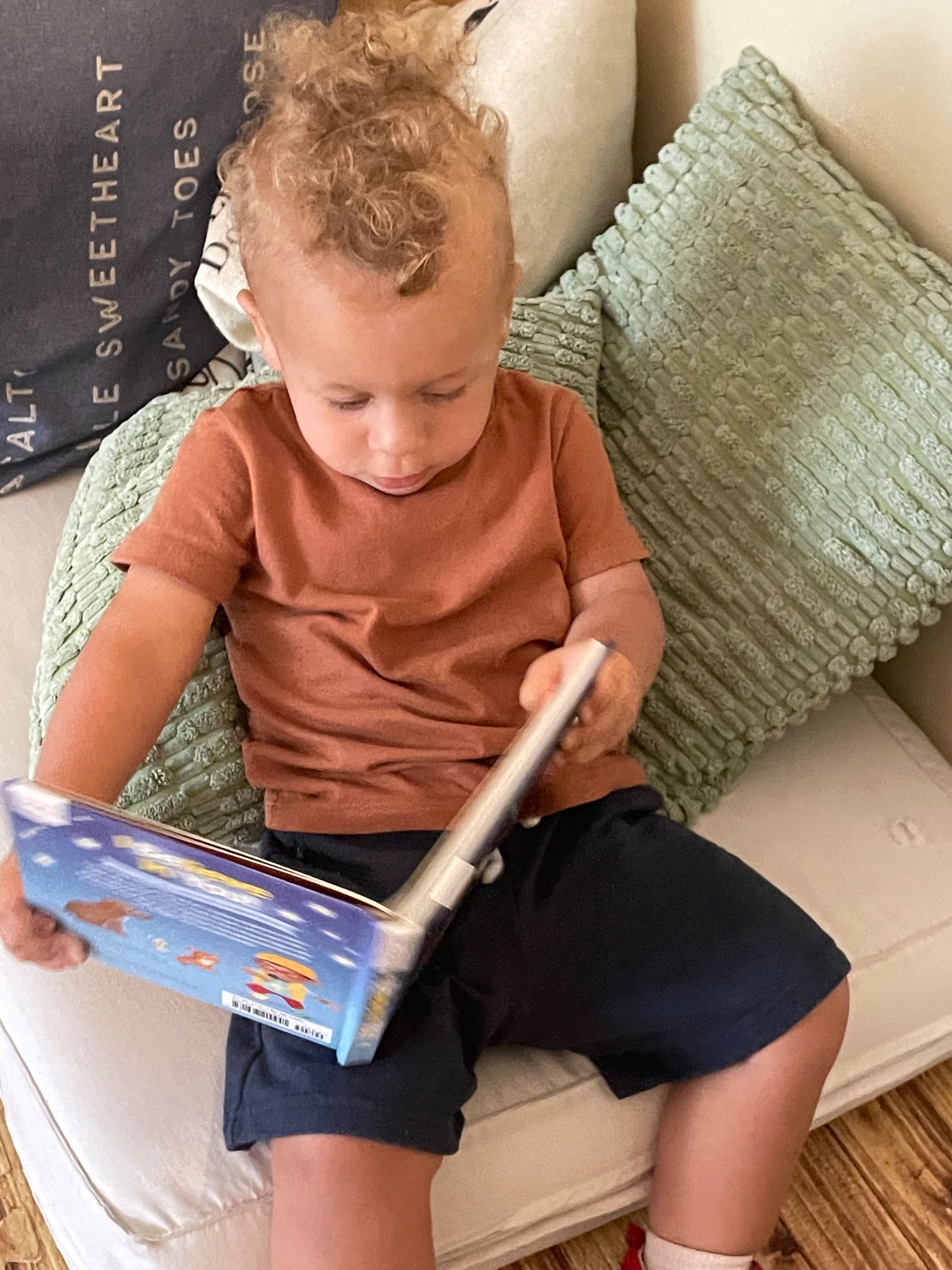 montessori child reading inside the classroom