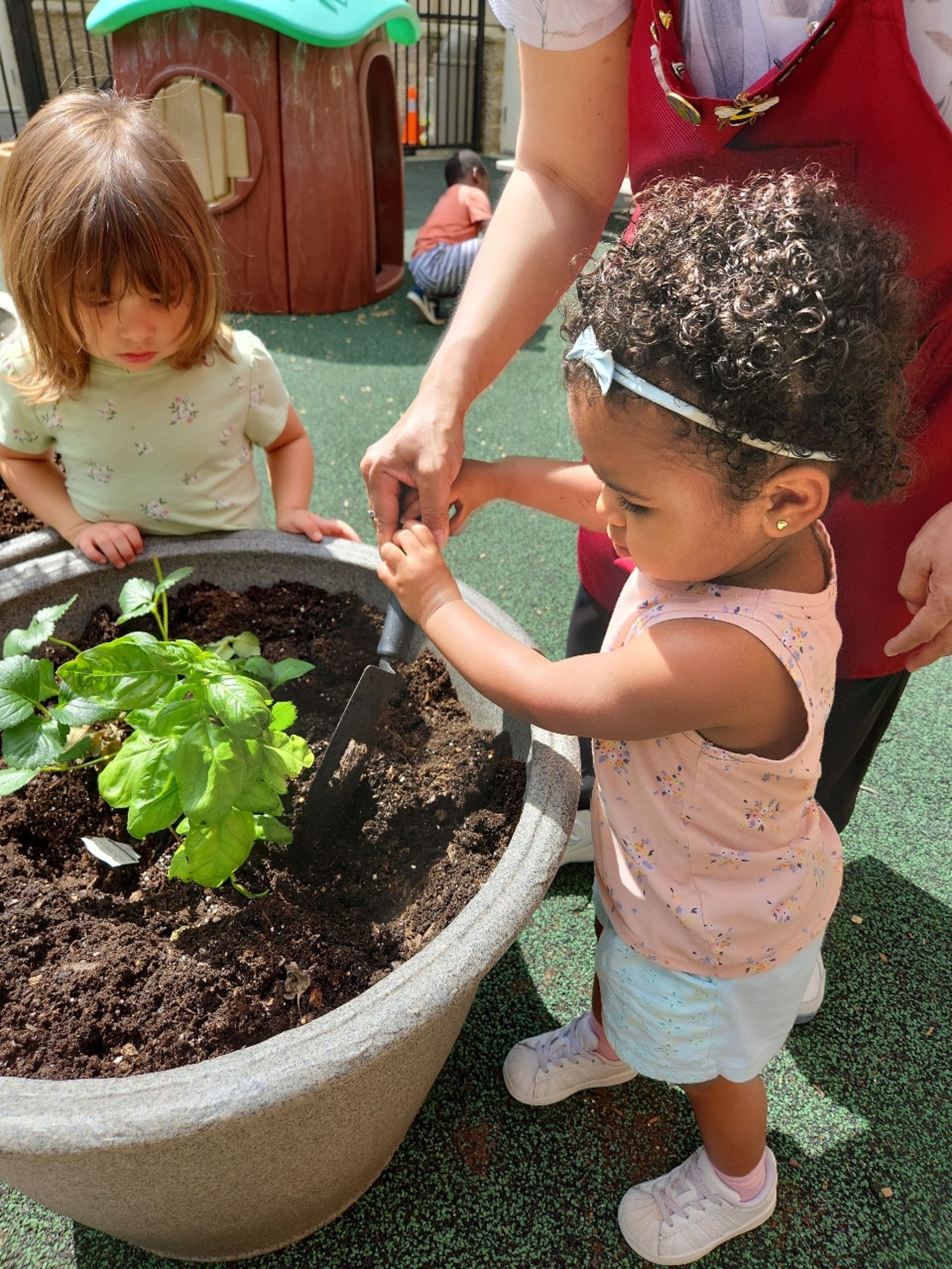 montessori child with guide outside activity