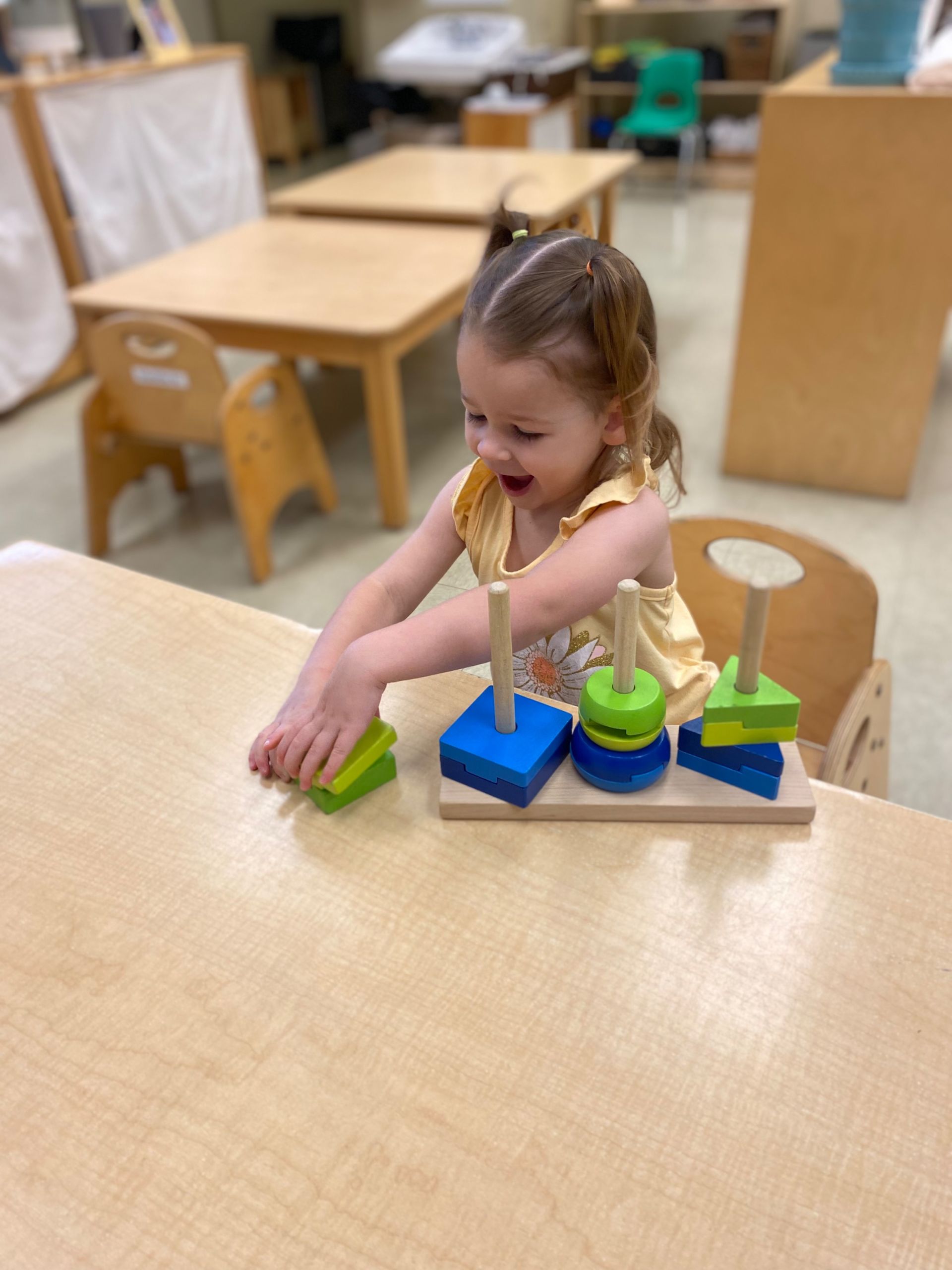 montessori child working with stacking shape activity