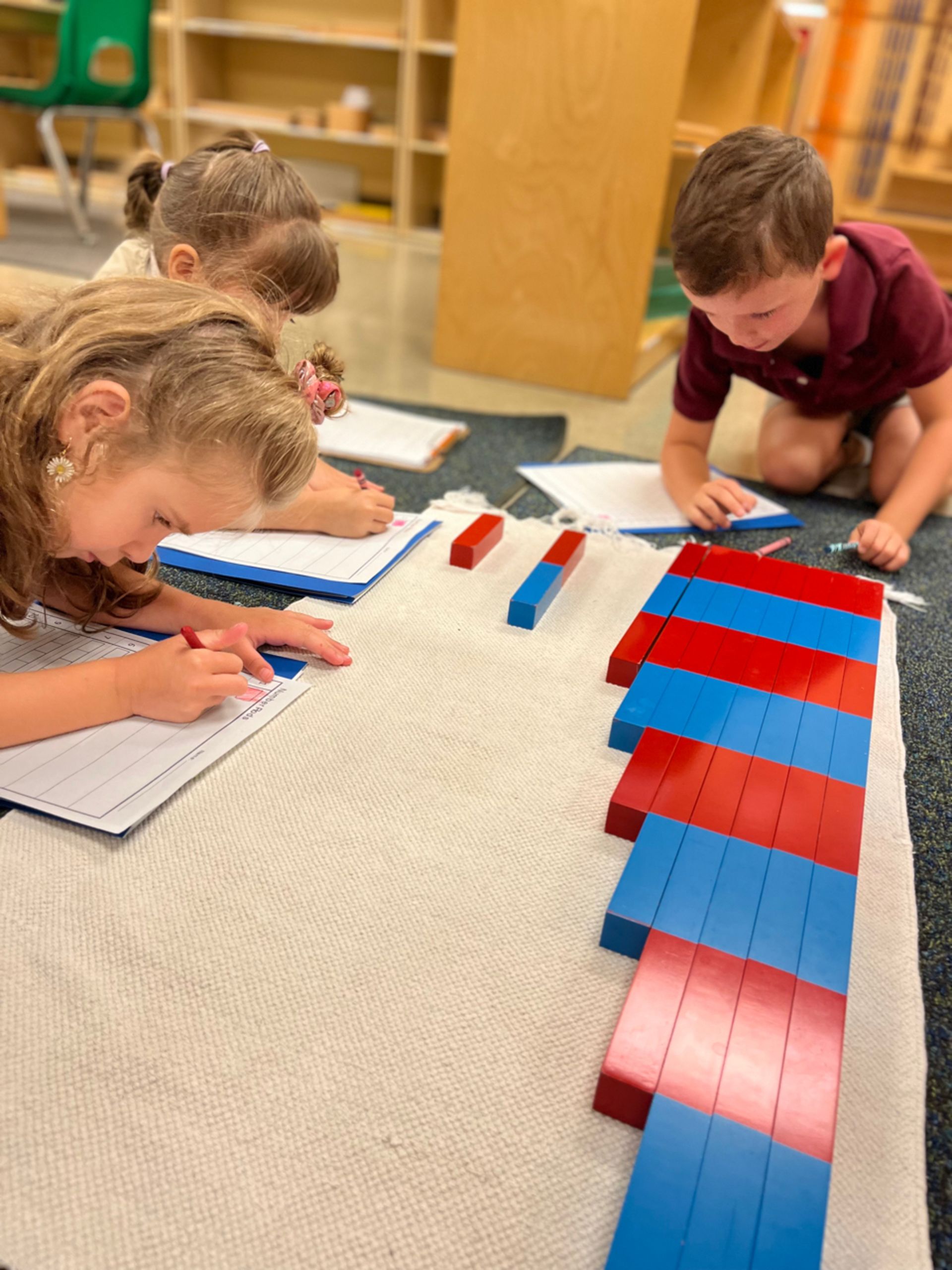 montessori children working together with math activity