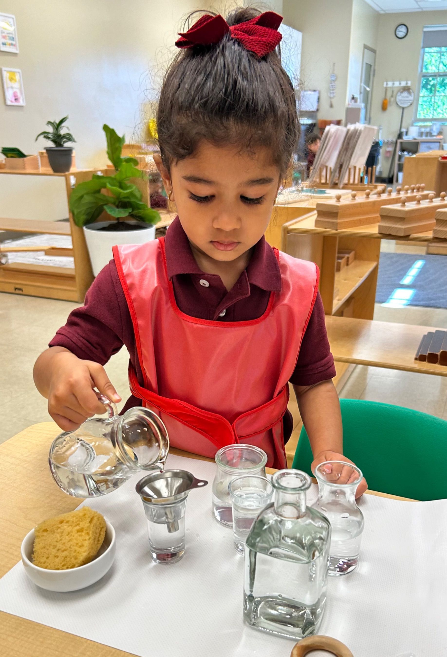 montessori primary child working with practical life skills