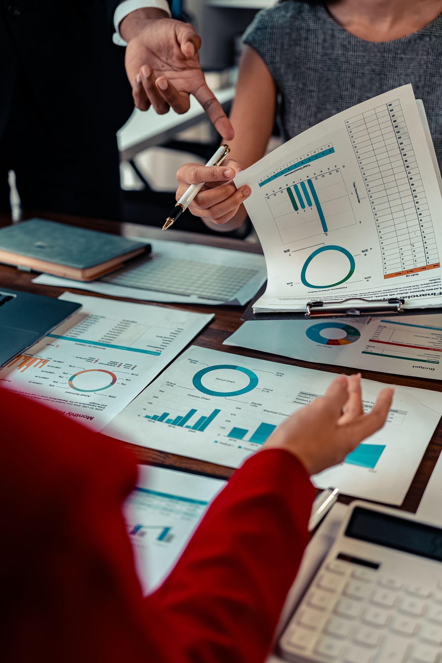 Close-up of blue-tinted employment and payroll documents with financial data and tables.