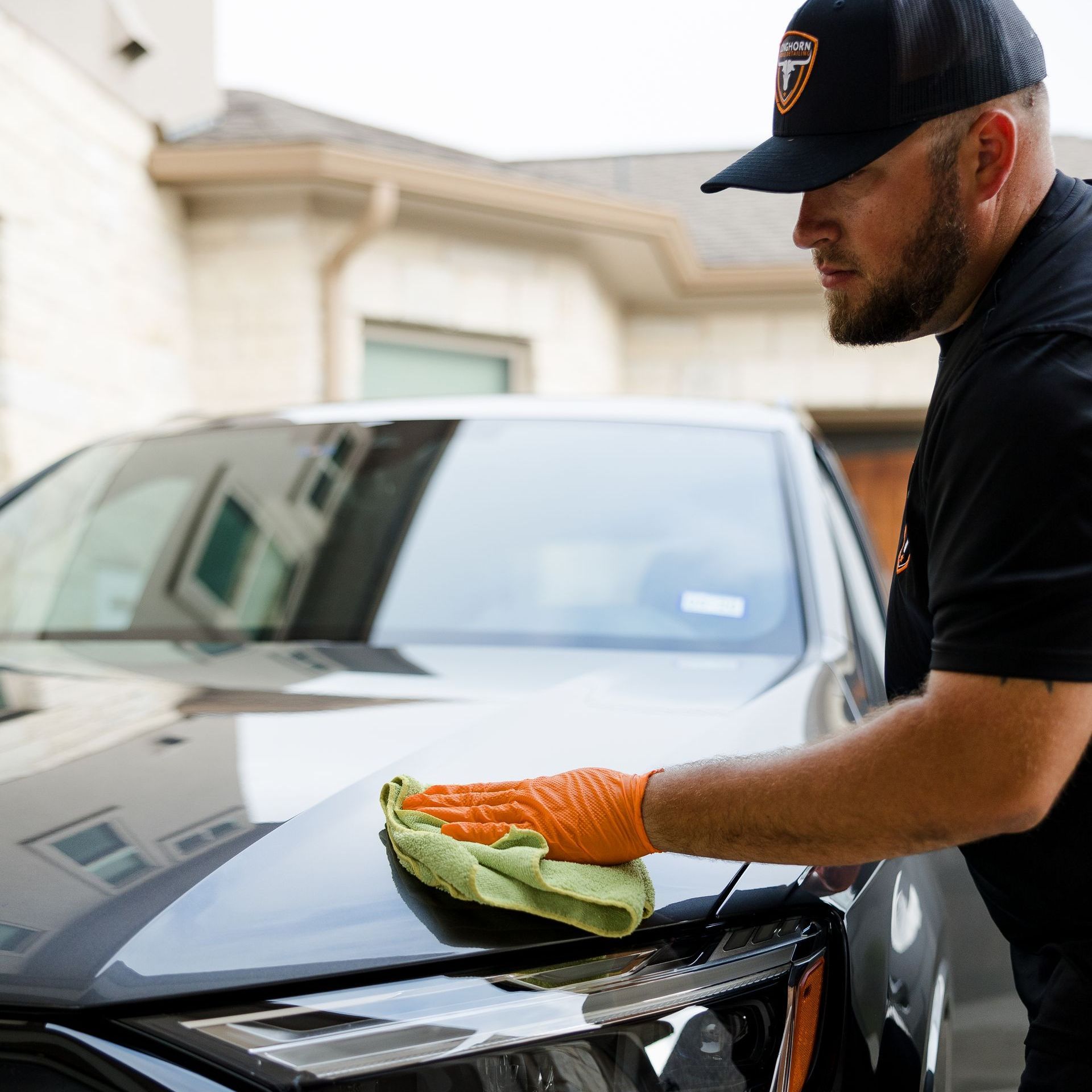 Wiping top of car after mobile car detailing in Austin, TX.