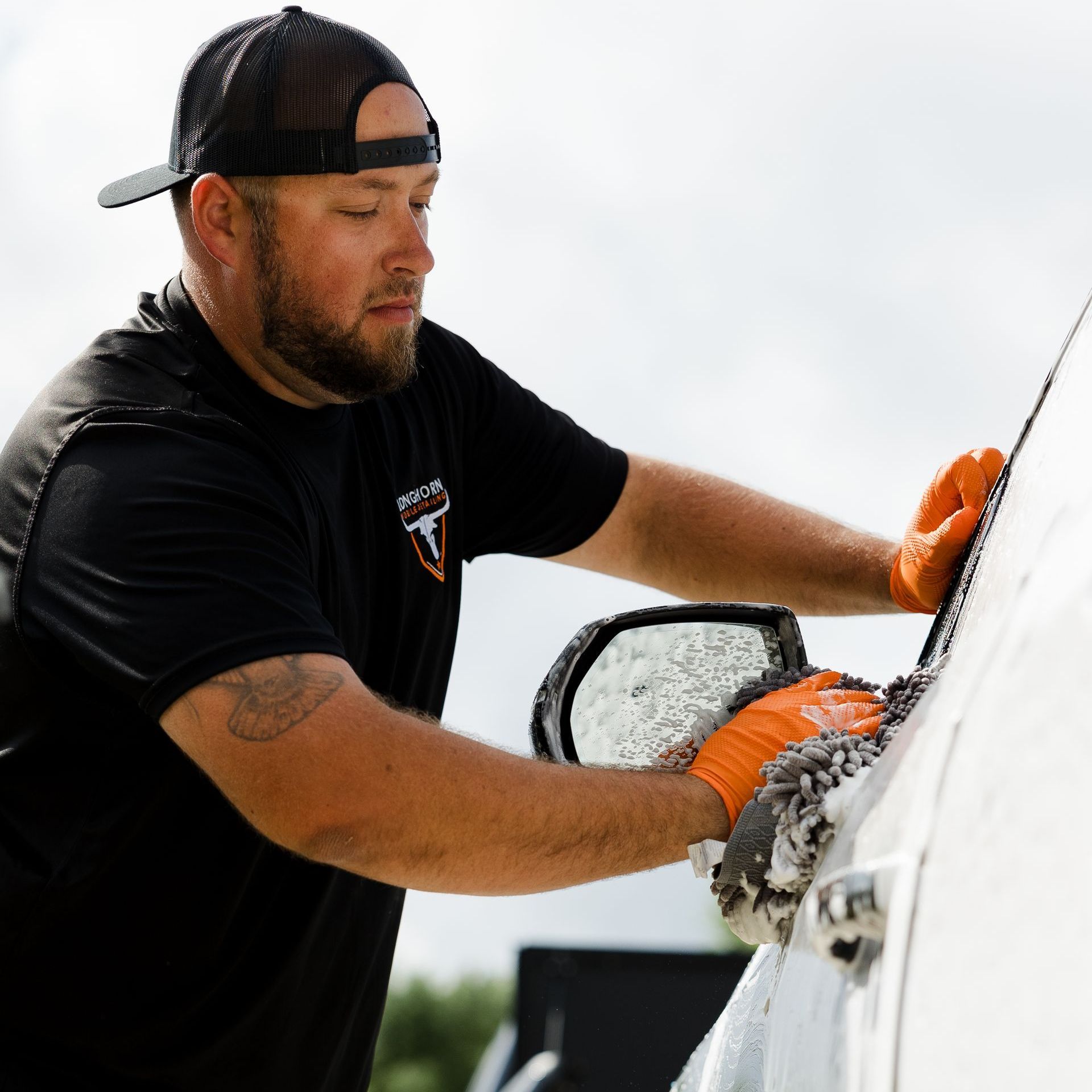 Silver Package | Mobile Car Detailing | Austin, Driftwood, Dripping Springs, Westlake, Bee Cave, and Lakeway, TX Man cleaning car wheel | Best mobile car and truck detailing with ceramic coatings in Austin, TX, Driftwood, TX, Dripping Springs, TX, Westlake, TX, Bee Cave, TX, and Lakeway, TX