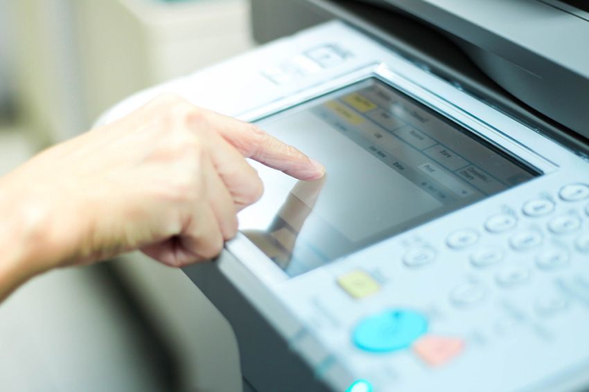 A Person is Pressing a Button on a Printer — Ardent Office Equipment in Hermit Park, QLD
