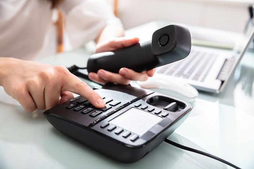 A Person is Holding a Telephone in Their Hand — Ardent Office Equipment in Hermit Park, QLD